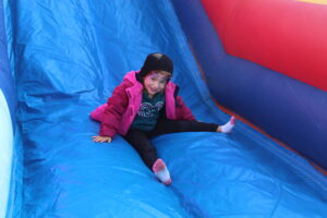 Girl sliding on inflatable slide.